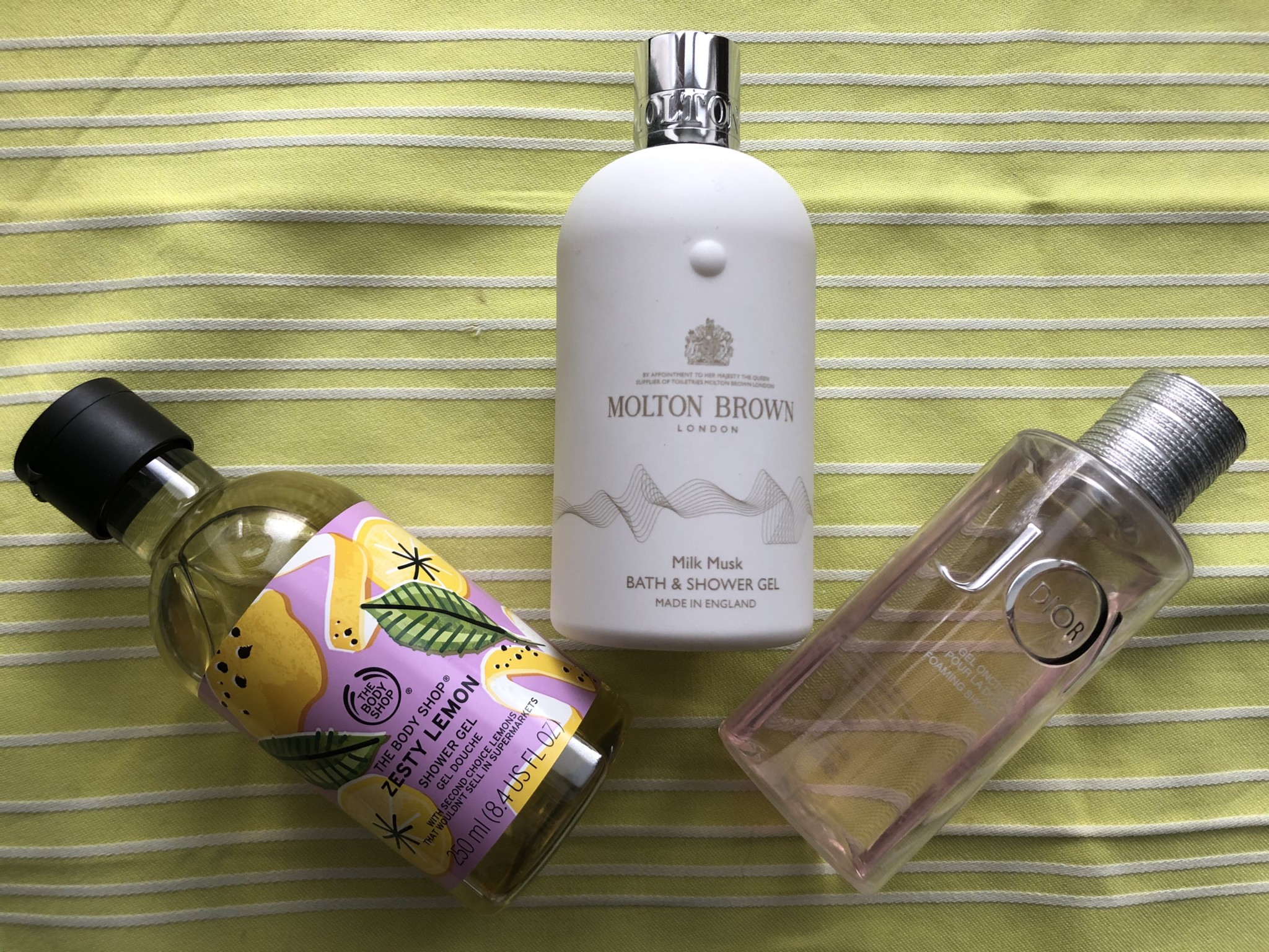 The Body Shop Zesty Lemon Shower Gel, Molton Brown Milk Musk Bath Shower Gel, Dior JOY Foaming Shower Gel.